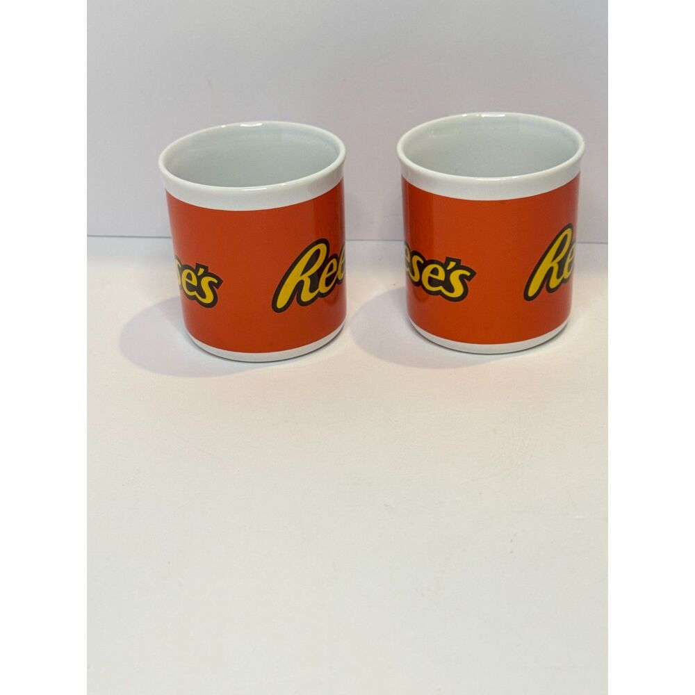 Reese’s Coffee Mug Set Lot of 2 Orange Ceramic Cups Galerie Peanut Butter Candy - Picture 2 of 6